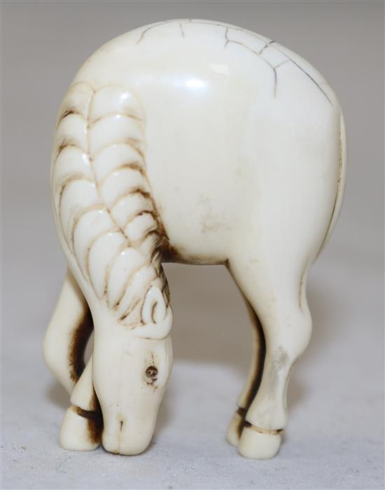 A Japanese stag antler netsuke of a horse, 18th/19th century, 4.9cm